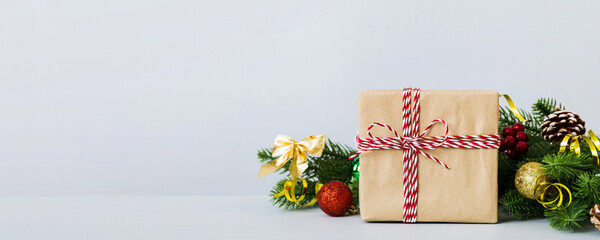 Wall Mural - New Year Christmas mood, gift box, branches of a christmas tree, New Year decorations on a colored background