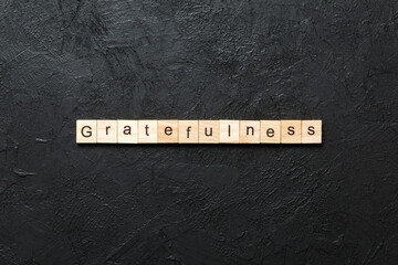 gratefulness word written on wood block. gratefulness text on cement table for your desing, concept