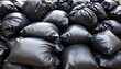 © Pod - Piles of black trash bags, likely containing waste or discarded items, stacked on top of each other in a cluttered, disorganized manner