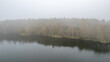 © Bjorn B - A peaceful and serene view of a tranquil lake, beautifully surrounded by colorful autumn foliage and soft mist