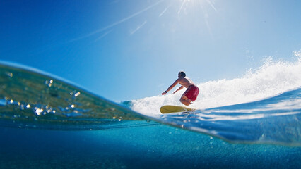 Aufkleber - Surfer is riding a wave with the scene from above and below the surface. Maldives