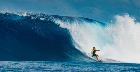 Wall Mural - Pro surfer rides big wave in the Maldives