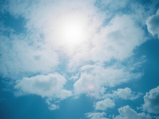 Poster - A clear blue sky filled with fluffy white clouds, showcasing the beauty of a sunny day, perfect for outdoor activities and nature photography.