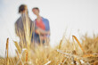 © Westend61 - Wheat crop in field with couple in background
