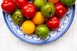© Westend61 - Colorful tomatoes in a decorative plate