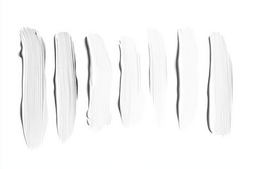 A row of white makeup brushes, each with a different length and width