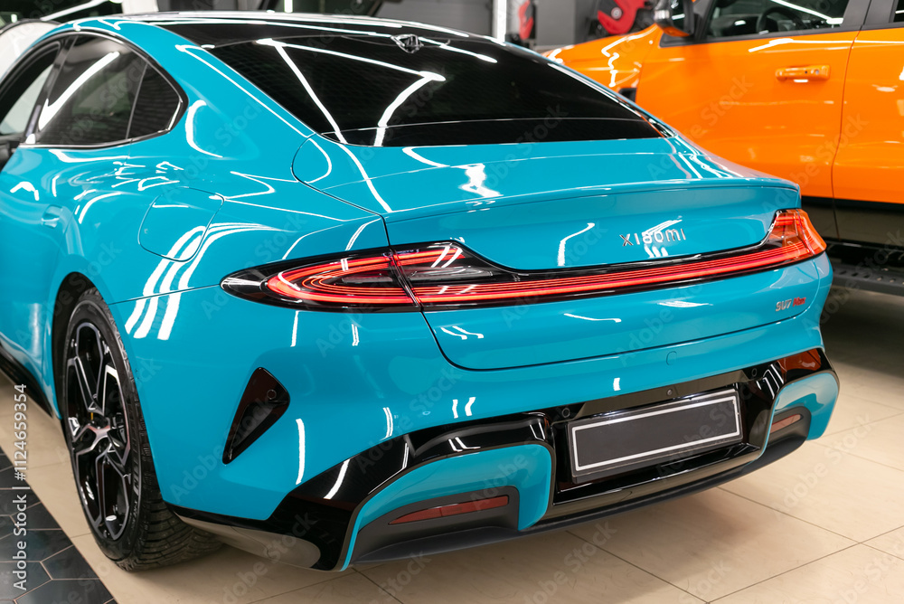 Su7 Rear Xiaomi SU7 turquoise color stands in the showroom rear view. Xiaomi SU7 ...