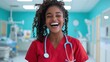 © JoxyAimages - A cheerful nurse wearing red scrubs and a blue stethoscope, smiling broadly, stands in a bright, modern hospital environment with medical equipment visible.