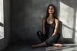 © YouraPechkin - Woman meditating in a sunlit corner of a minimalist room during the afternoon