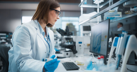 Aufkleber - Caucasian Female Research Scientist Using Computer in a Modern Laboratory. Scientists are Conducting Research with the Help of Microscopes and Desktop Computers