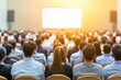© Anna - In a modern, well-lit auditorium, a large audience attends a business conference, focusing on speakers on stage and a presentation screen.