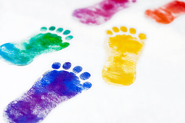 Colorful painted footprints on paper, likely for a creative or educational project.