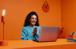 © Jacob Lund - Tech recruiter woman clapping while using laptop in bright, wireless workspace