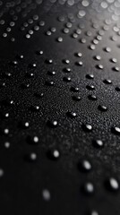 Poster - Water droplets creating a textured pattern on a dark surface