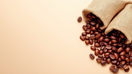 Wall Mural - Two burlap sacks spill roasted coffee beans on a smooth surface, showcasing rich textures and warm colors.