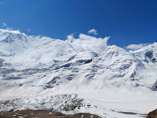 Wall Mural - Snowy peaks soar against a clear blue sky, highlighting nature beauty in a remote mountain region