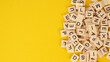 © nisara - wooden letter cubes isolated on yellow background
