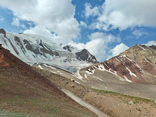 Wall Mural - Snowy peaks tower against a colorful sky, highlighting nature\'s beauty in a remote mountain area