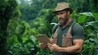 © Evgenii - man in a green shirt and hat examines a clipboard in a vibrant tropical forest. Surrounded by rich foliage, he appears deep in thought about his conservation project and research