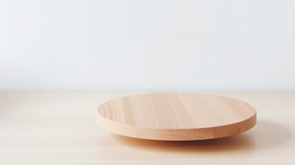 Wall Mural - Elegant round wooden serving platter. Wooden podium on soft, neutral kitchen background.