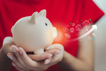 person holding piggy bank with financial growth symbols, representing savings and investment. image conveys sense of financial planning and prosperity