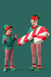 © Pixel-Shot - Shocked little children in elves costumes with candy cane pinata on green background