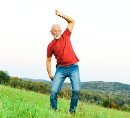 Wall Mural - man outdoor senior happy lifestyle retirement dancing nature mature active elderly vitaliti training