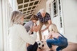 © Marko Geber - Happy grandparents playing soccer with grandchildren on home porch