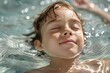 © Fotograf - A young boy swims underwater with his eyes closed