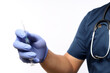 © ArvStd - Confident asian male nurse, doctor in medical rubber gloves, holding syringe with vaccine, standing white background