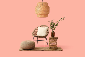 Canvas Print - Table with bamboo stems in vase, armchair, pouf and lamp on pink background