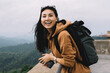 © BullRun - Happy asian female traveler with backpack laughing and enjoying free time on weekends explore location, smiling woman tourist excited with free time recreating on journey standing on historical place