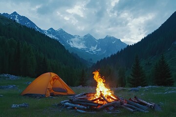 bonfire burning in tourist camp in mountains. beautiful campfire, burning wood by tent in summer eve