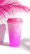 © Putu - Vibrant pink takeaway coffee cup with palm leaf design, against a bright white background with pink palm leaf shadows.  Perfect for summer branding or tropical themes.