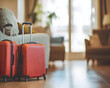Two red suitcases placed beside a couch in a cozy living room setting.