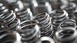 © MetaPixel - Close-up view of numerous stainless steel springs arranged in an abstract pattern showcasing their reflective surfaces and circular shapes
