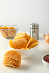 Wall Mural - Potato chips in a bowl on a white table