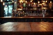 © adri - Empty wooden table in front of blurred bar background.