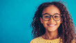 © mahamad - A headshot portrait of a happy mixed-race girl wearing glasses.