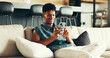 © peopleimages.com - House, relax and man on sofa, smartphone and typing with social media, connection and network. Apartment, person and guy on couch, cellphone and message to contact, digital app and texting in lounge