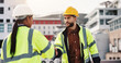 © peopleimages.com - Architecture, man and woman on building shaking hands for inspection, agreement or introduction in city. Civil engineering, contractor and technician on roof with handshake, deal or teamwork on site