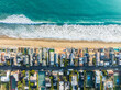 © Monet_P - Aerial View of Coastal Homes and Turquoise Sea Waves