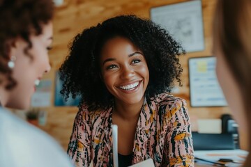 Poster - A woman with curly hair is smiling at the camera