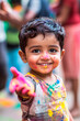 © Marc Elias - Smiling child celebrating Holi with vibrant colors