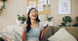 © peopleimages.com - Winner, phone and success with woman on sofa for bonus, online shopping deal and achievement. Good news, social media post and celebration with person in living room at home for happiness and wow