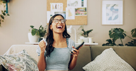 Fototapete - Winner, phone and success with woman on sofa for bonus, online shopping deal and achievement. Good news, social media post and celebration with person in living room at home for happiness and wow