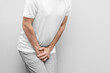 © ATRPhoto - Person with urinary problems, Medical problem urinary incontinence. people with crotch pain, Man with hands on crotch with urinary problems