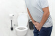 © ATRPhoto - Person with urinary problems, Medical problem urinary incontinence. people with crotch pain, Man with hands on crotch with urinary problems