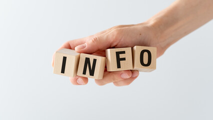 Aufkleber - A hand holding a wooden block with the letters Info on it