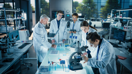 Leinwandbilder - Head of Laboratory Making a Bioengineering Experiment with a Group of Young Science College Students. Future Specialists Working with Modern Microscopes, Using Tablet and Laptop Computers